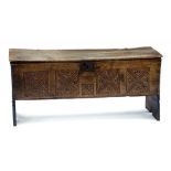 AN 18TH CENTURY AND LATER BOARDED OAK CHEST WITH CARVED FRONT 58CM X 129CM