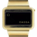 AN OMEGA GOLD PLATED DIGITAL WRISTWATCH, CALIBRE 1602, MAKER'S BRACELET, BOOKLET AND BOX