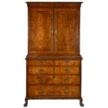 A DUTCH WALNUT AND FEATHERBANDED CUPBOARD, 18TH C the waist mouldings with central slide, on
