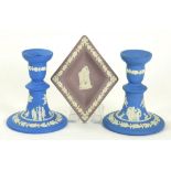 A PAIR OF WEDGWOOD SOLID BLUE JASPERWARE DWARF CANDLESTICKS 12.5CM H AND A WEDGWOOD SOLID LAVENDER