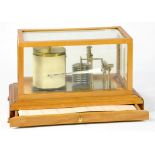 A SEWILLS LACQUERED BRASS BAROGRAPH WITH NICKEL DIAPHRAGM IN OAK CASE WITH BEVELLED GLASS LIGHT