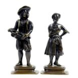 A PAIR OF NORTHERN EUROPEAN BRONZE STATUETTES OF ITINERANTS, THE MAN PLAYING THE HURDY GURDY, HIS