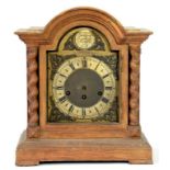 A GERMAN MAHOGANY BREAK ARCHED BRACKET CLOCK WITH BRASS DIAL AND SILVERED CHAPTER RING FLANKED BY