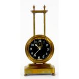 A FRENCH BRASS GRAVITY DRIVEN TIMEPIECE, THE GLASS DIAL WITH VISIBLE PENDULUM, 25CM H, CIRCA 1900