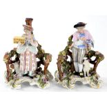 A PAIR OF SITZENDORF FLORAL ENCRUSTED FIGURES OF A YOUTH AND GIRL EMBLEMATIC OF LIBERTY AND