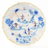 A FRENCH FAIENCE SINGERIE PLATE PAINTED IN BLUE AND MANGANESE WITH DANCING MONKEYS, 25CM DIAM