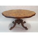A Victorian walnut loo table with shaped top, turned pedestal and four carved shaped legs,