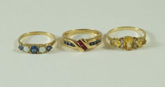 A 9 carat gold citrine and diamond dress ring; a sapphire and ruby 9 carat gold dress ring;