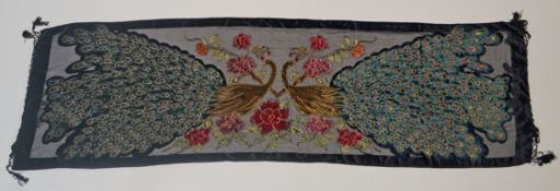 A velvet stole hand beaded with two peacocks and flowers on a black ground, 75.
