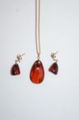 An amber pendant and earrings,