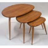 A nest of three Ercol tables, each with three turned tapering legs, manufacturers label, 39cm high,