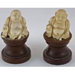 A pair of early 20th century carved ivory figures of Buddha seated,