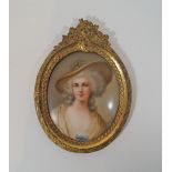 An early 20th century German porcelain plaque painted with a lady wearing a hat, signed Wagman,