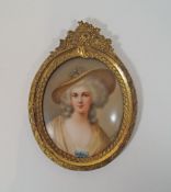 An early 20th century German porcelain plaque painted with a lady wearing a hat, signed Wagman,