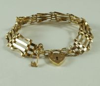 A 9 carat gold bracelet, of four bar gate link design to a padlock clasp with safety chain, 8.
