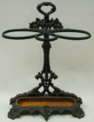 A Victorian cast iron umbrella stand, painted green,