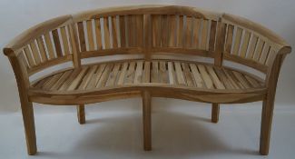 A 20th century wooden garden bench of curved form on square legs,