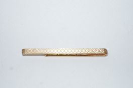 A 9 carat gold tie slide, with engine turned decoration, 6cm long, 6.