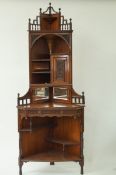 An early 20th century aesthetic movement rosewood corner cabinet, with pierced and carved panels,