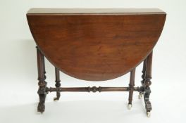 A Victorian mahogany oval drop leaf tea table, on turned legs with ceramic casters, 71cm high,