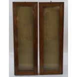 A pair of oak shop hanging display cabinets, each with a hinged glazed door, 120cm high, 39.