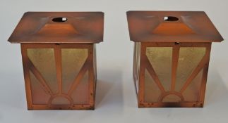 A pair of Art Deco style lamp shades with copper effect frames and tinted, frosted glass panels,