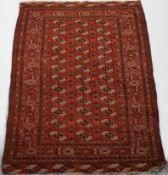 WITHDRAWN A Tekke Tukoman rug with three rows of twelve guls on a red field,