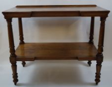 A 19th century oak two tier buffet on turned supports on casters, 96cm high, 119cm wide, 61.