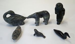 A collection of six Inuit carvings, comprising of a duck, a figure, a polar bear, an oil lamp,