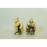 Two early 20th century stained ivory netsuke, each of a figure holding a fruit, 5.6cm high and 5.