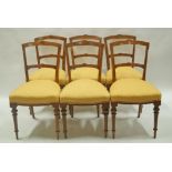 A set of six Victorian walnut marquetry chairs with turned and fluted legs