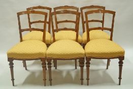 A set of six Victorian walnut marquetry chairs with turned and fluted legs