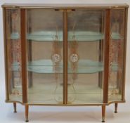 A 1960s display cabinet with walnut effect carcass and painted glazed doors, 101cm high, 106cm wide,