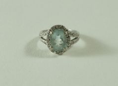 An aquamarine and diamond cluster ring, the white mount stamped '14K',