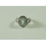 An aquamarine and diamond cluster ring, the white mount stamped '14K',