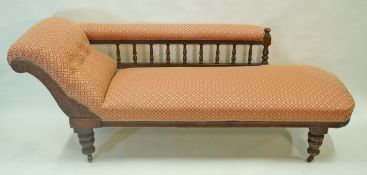 An Edwardian mahogany framed chaise longue with aesthetic style uprights and legs with ceramic