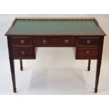 An Edwardian mahogany desk with pierced gallery back,