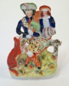A Victorian Staffordshire pottery group of two highlanders and a dog,