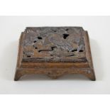 An early 20th century Japanese base metal stamp box, the pierced cover moulded with cranes,