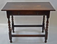 An oak side table with one frieze drawer linked by stretchers, 75cm high, 94cm wide,