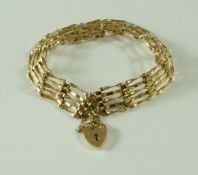 A 9 carat gold bracelet, of five bar gate link design, to a padlock clasp with safety chain,
