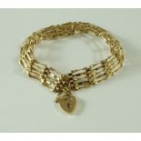 A 9 carat gold bracelet, of five bar gate link design, to a padlock clasp with safety chain,