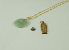 A 9 carat gold necklace; with a carved jade pendant carved as two confronting fish;