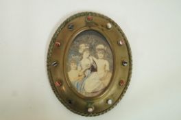 A late 19th century tinted photographic portrait of three young girls, in oval gilt brass frame,
