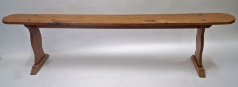 A French fruitwood bench, the shaped legs with flared plinth base, 48cm high, 198cm long, 21.