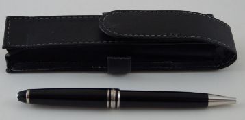 A Mont Blanc black Meisterstuck ballpoint pen in a leather pouch