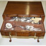 An oak two drawer canteen on slender cabriole legs and a quantity of silver plated flatware,