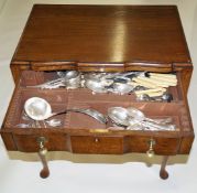 An oak two drawer canteen on slender cabriole legs and a quantity of silver plated flatware,