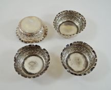 Set of four silver salts, of circular outline with embossed decoration, London 1890,
