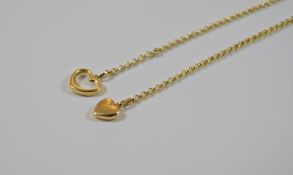 A gold chain with two heart pendants, marked 14K, 5.